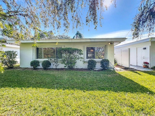 ranch-style home featuring a front yard