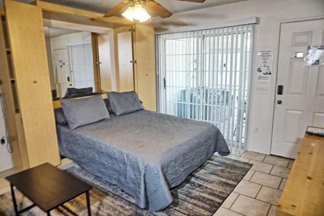 bedroom with light tile patterned flooring, access to exterior, and ceiling fan