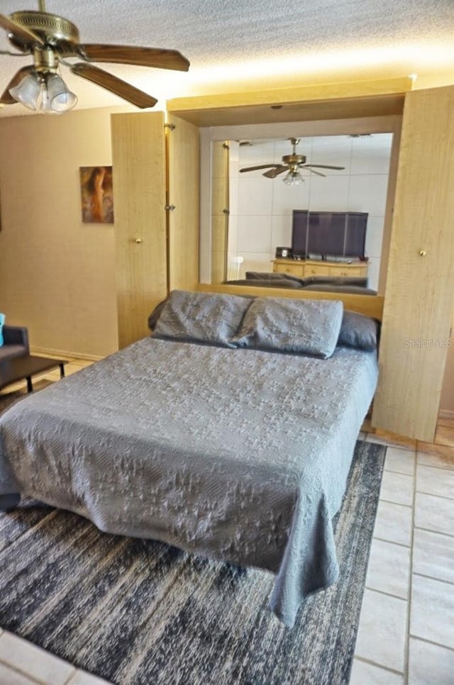 tiled bedroom featuring a textured ceiling