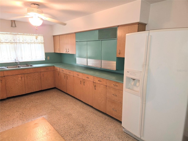 kitchen featuring white refrigerator with ice dispenser, sink, and ceiling fan