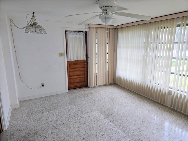 spare room featuring a wealth of natural light and ceiling fan