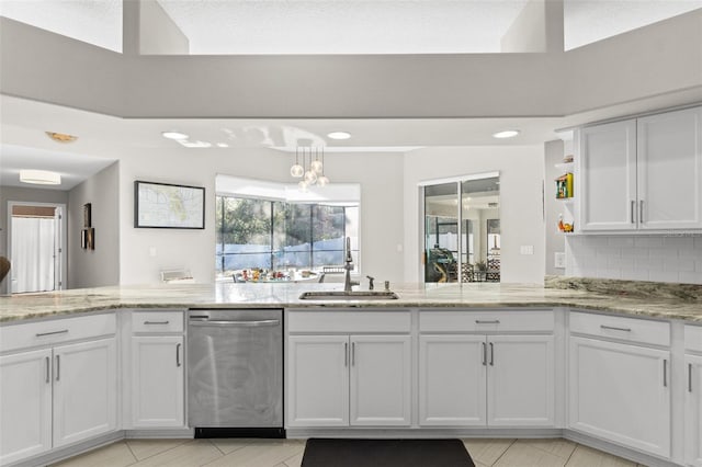 kitchen with sink, dishwasher, backsplash, light stone counters, and white cabinets