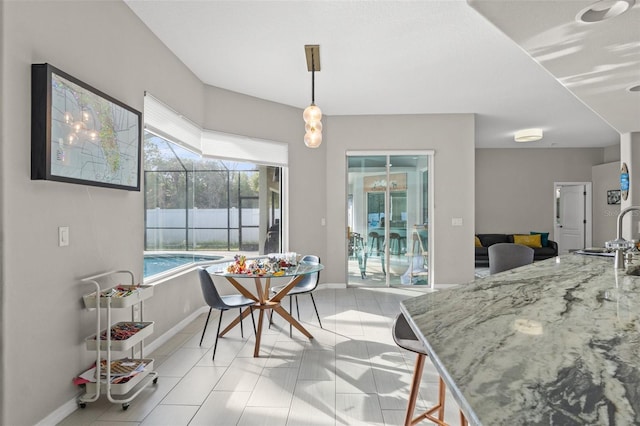 dining space with sink and light tile patterned floors