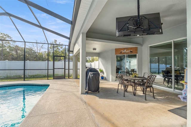 view of pool featuring a grill, glass enclosure, and a patio area