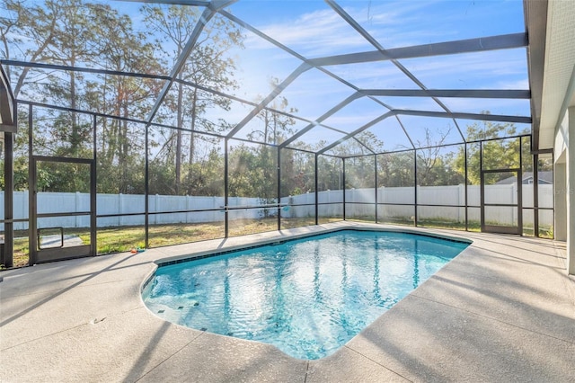 view of swimming pool featuring a patio and glass enclosure