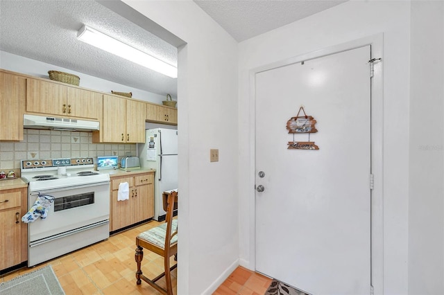 kitchen with tasteful backsplash, white appliances, light brown cabinets, a textured ceiling, and light wood-type flooring