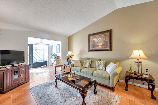 living room featuring light hardwood / wood-style floors, vaulted ceiling, and a textured ceiling