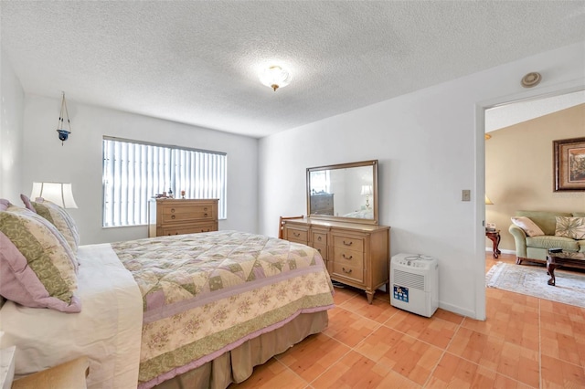 bedroom featuring light hardwood / wood-style flooring and a textured ceiling