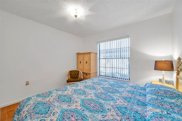 bedroom featuring a textured ceiling and light wood-type flooring