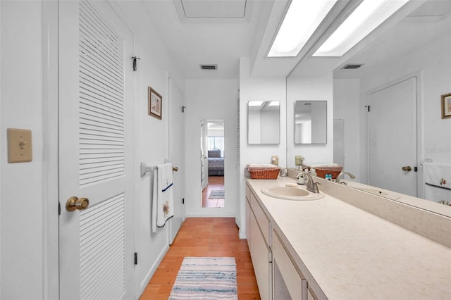 bathroom with hardwood / wood-style flooring and vanity