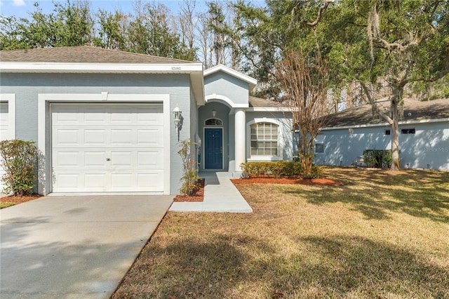 single story home featuring a garage and a front lawn