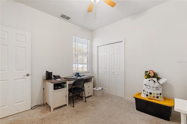 carpeted office with ceiling fan