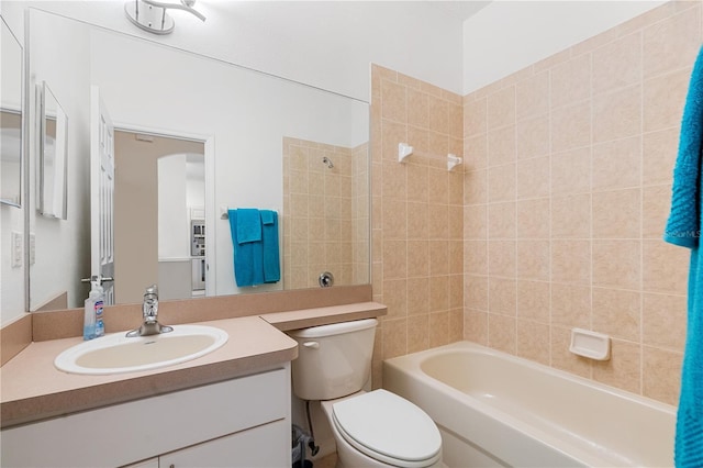 full bathroom featuring vanity, tiled shower / bath combo, and toilet