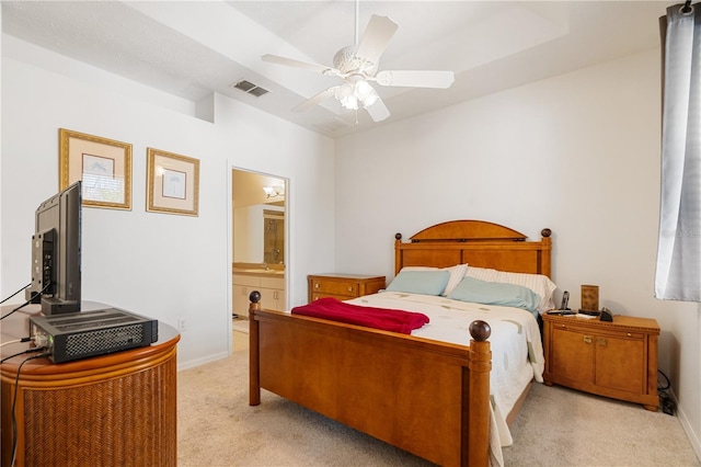 carpeted bedroom with ceiling fan and ensuite bath