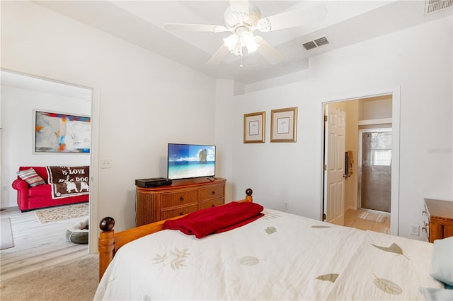 bedroom with ceiling fan and ensuite bath