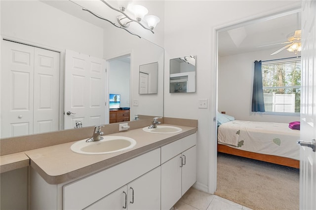 bathroom featuring tile patterned flooring, vanity, and ceiling fan with notable chandelier