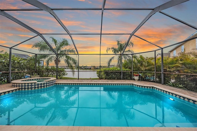 view of pool with glass enclosure and a pool with connected hot tub