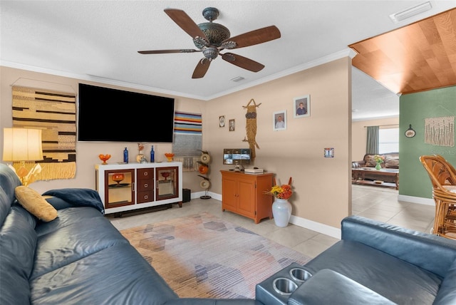 living room with light tile patterned flooring, ceiling fan, and crown molding