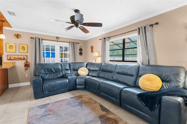 living room featuring light tile patterned floors, crown molding, and a wealth of natural light