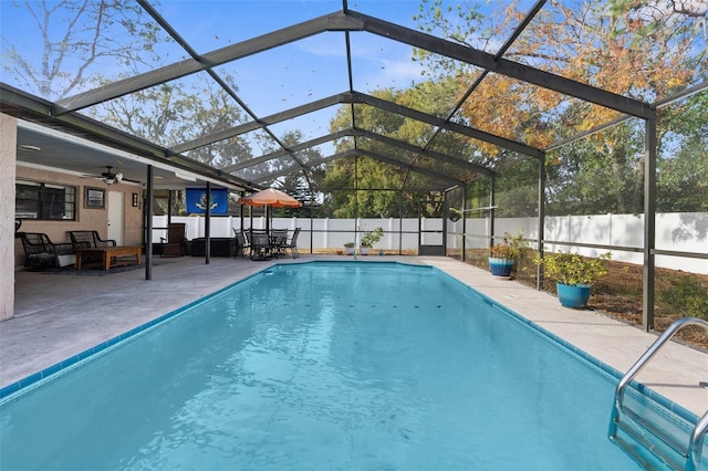 view of swimming pool featuring a patio, a lanai, and ceiling fan