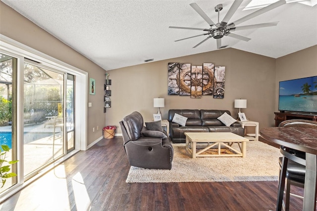 living room featuring ceiling fan, lofted ceiling, dark hardwood / wood-style floors, and a textured ceiling