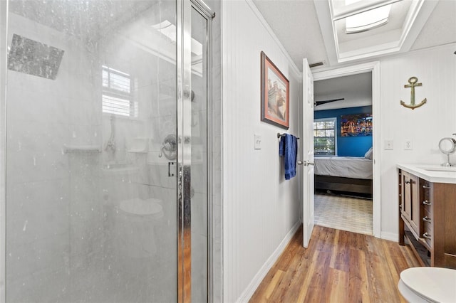 bathroom with vanity, wood-type flooring, a shower with shower door, and toilet