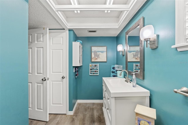 bathroom featuring vanity, hardwood / wood-style floors, and a textured ceiling