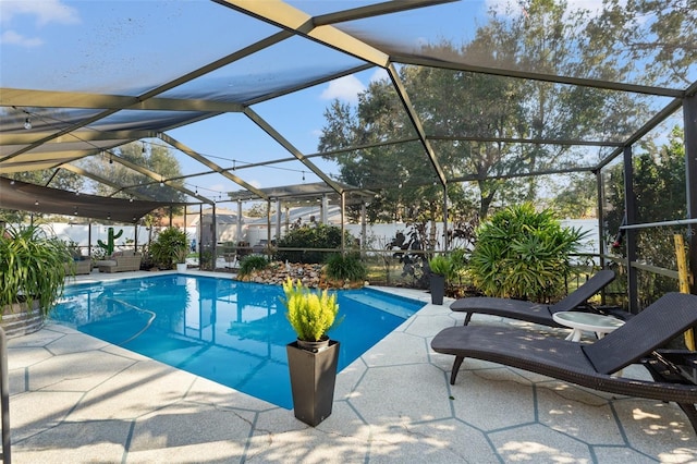 view of swimming pool featuring a lanai and a patio