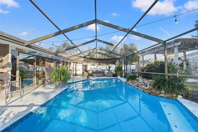 view of pool with a lanai, an outdoor hangout area, and a patio area