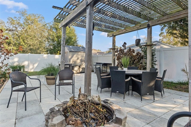 view of patio featuring a storage shed and a pergola