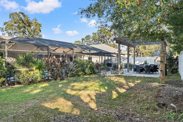 view of yard with a patio and glass enclosure