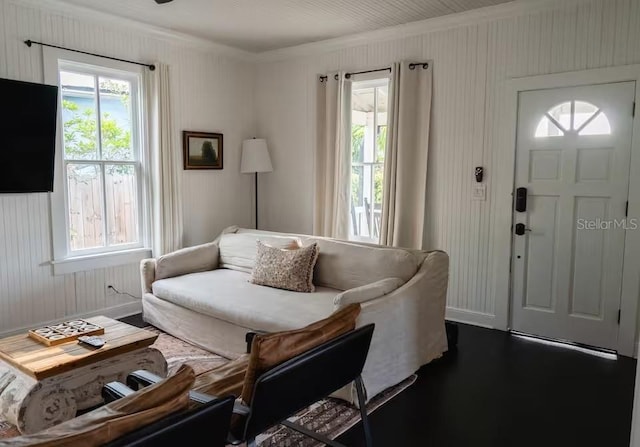 living room with crown molding, a healthy amount of sunlight, and dark hardwood / wood-style flooring