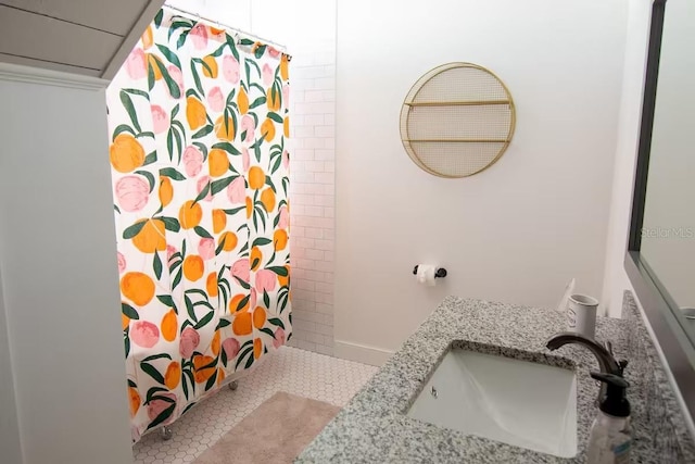 bathroom featuring tile patterned flooring, vanity, and walk in shower