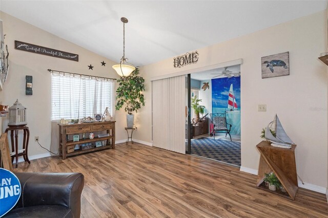 sitting room with vaulted ceiling and hardwood / wood-style floors