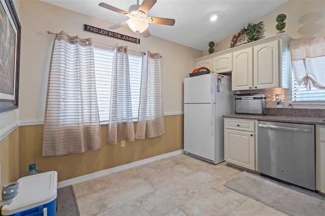 kitchen with ceiling fan, white cabinetry, vaulted ceiling, stainless steel dishwasher, and white fridge