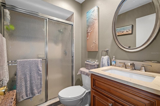 bathroom featuring vanity, toilet, and an enclosed shower