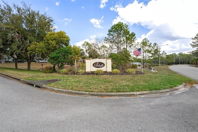 community / neighborhood sign with a yard