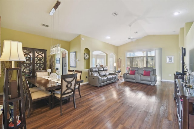 dining room featuring dark wood-type flooring, ceiling fan, and vaulted ceiling