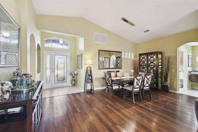 dining area featuring dark hardwood / wood-style floors and high vaulted ceiling