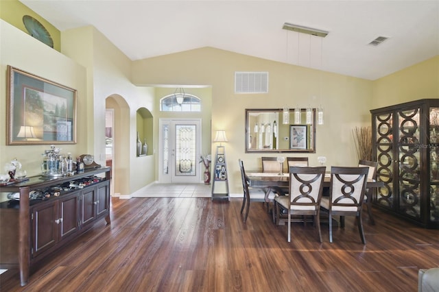 dining area with dark hardwood / wood-style flooring and lofted ceiling