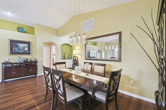 dining room with lofted ceiling and dark hardwood / wood-style flooring