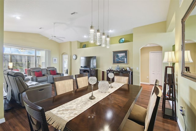 dining room with ceiling fan, lofted ceiling, and dark hardwood / wood-style flooring