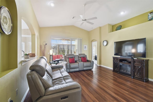 living room featuring dark wood-type flooring, ceiling fan, and vaulted ceiling