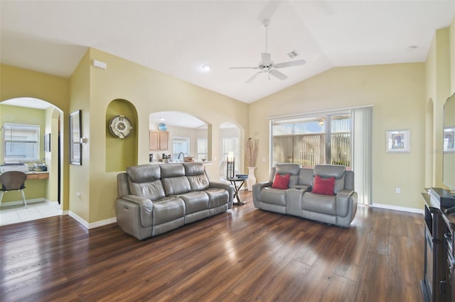 living room featuring ceiling fan, dark hardwood / wood-style flooring, and vaulted ceiling