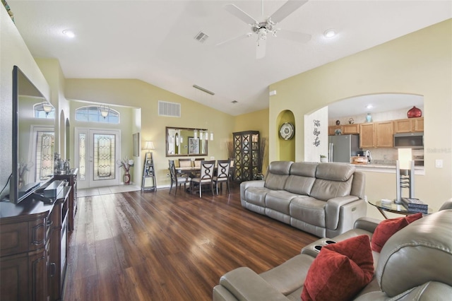 living room featuring dark wood-type flooring, ceiling fan, and vaulted ceiling