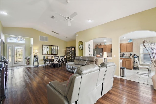 living room featuring lofted ceiling, hardwood / wood-style flooring, and ceiling fan