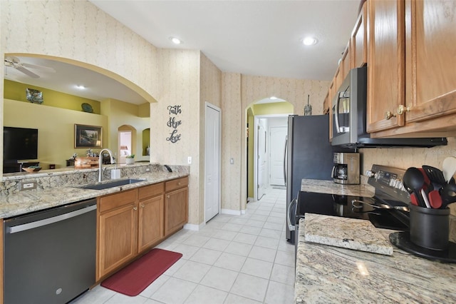 kitchen featuring sink, electric range oven, black dishwasher, light stone countertops, and light tile patterned flooring