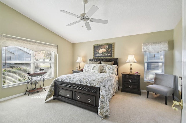 bedroom with vaulted ceiling, light colored carpet, and ceiling fan