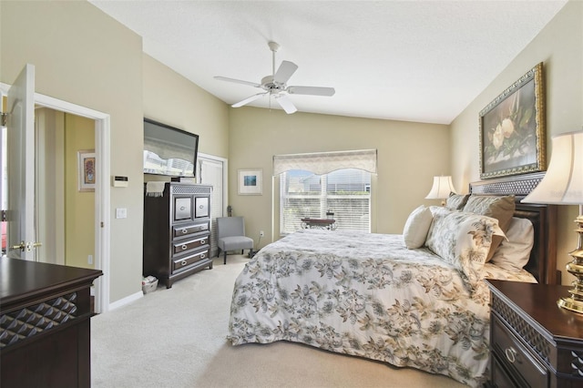 bedroom featuring ceiling fan, light colored carpet, and vaulted ceiling