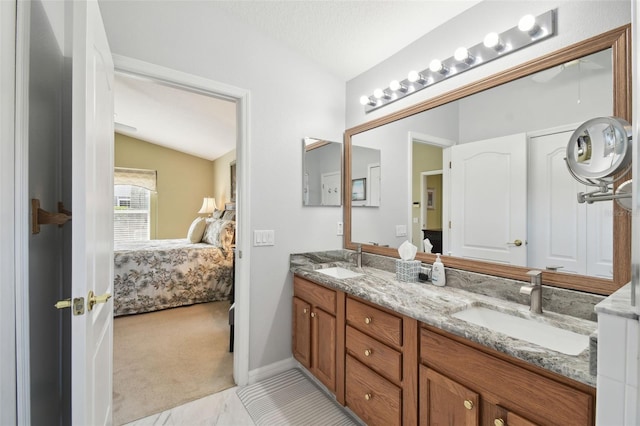 bathroom with vaulted ceiling and vanity